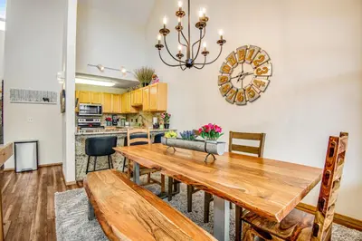 a dining room with a table and a clock on the wall at Forest Park 31E in Silverthorne