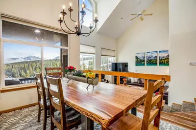 a dining room with a wooden table and chairs at Forest Park 31E in Silverthorne