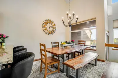 a dining room with a wooden table and chairs at Forest Park 31E in Silverthorne