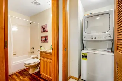 a bathroom with a toilet and a tv on the wall at Forest Park 31E in Silverthorne