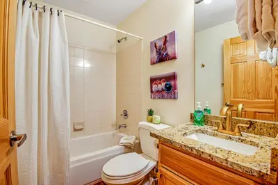 a bathroom with a tub and a toilet and a sink at Forest Park 31E in Silverthorne