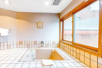 a large bathroom with a tub and a window at Buffalo Ridge Retreat in Silverthorne