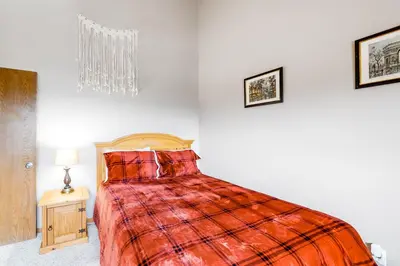 a bedroom with a bed with a red blanket at Buffalo Ridge Retreat in Silverthorne