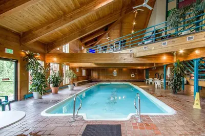 an indoor pool in a building with an indoor staircase at Buffalo Ridge Retreat in Silverthorne
