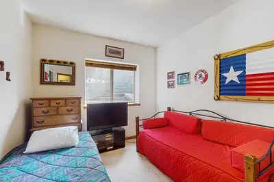 a living room with a red couch and a television at Lookout Ridge 63 in Dillon