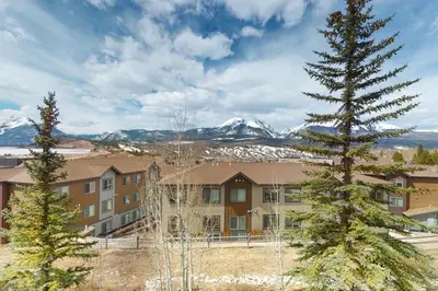 a large apartment building with mountains in the background at Lookout Ridge 63 in Dillon