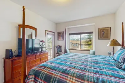 a bedroom with a bed and a flat screen tv at Lookout Ridge 63 in Dillon