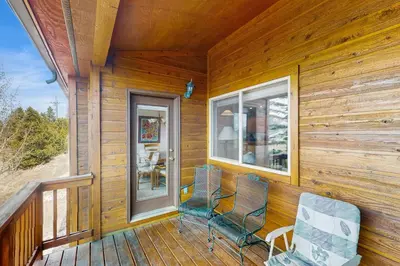 two chairs sitting on the porch of a cabin at Lookout Ridge 63 in Dillon