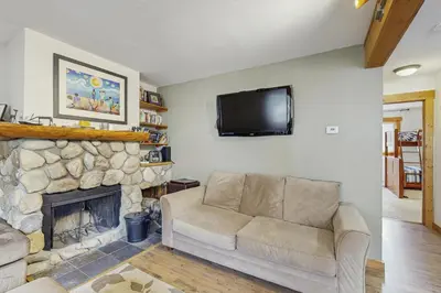a living room with a couch and a fireplace at Ore House 8 in Frisco