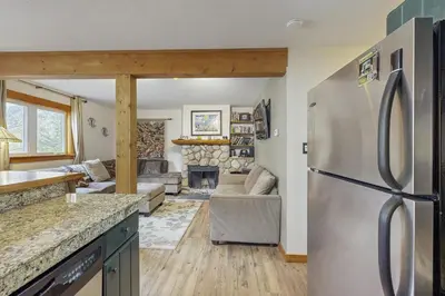 a kitchen and living room with a stainless steel refrigerator at Ore House 8 in Frisco