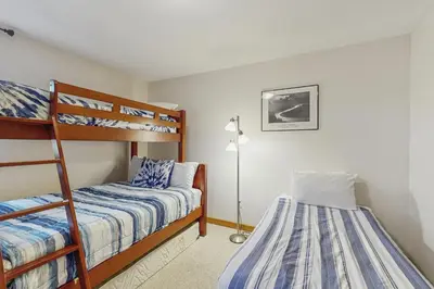 a bedroom with two bunk beds and a lamp at Ore House 8 in Frisco