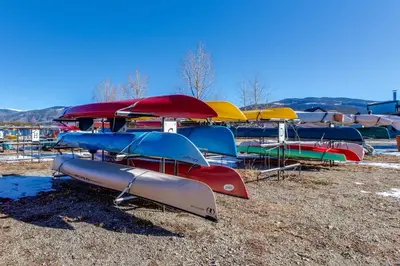 a group of kayaks and umbrellas on a field at Ore House 8 in Frisco