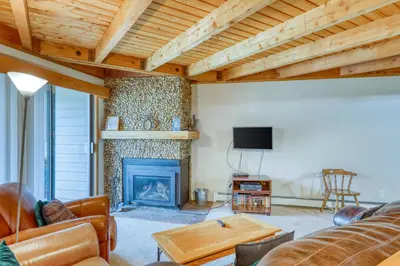 a living room with a couch and a fireplace at Treehouse 206F in Silverthorne
