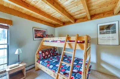 a bedroom with bunk beds in a cabin at Treehouse 206F in Silverthorne