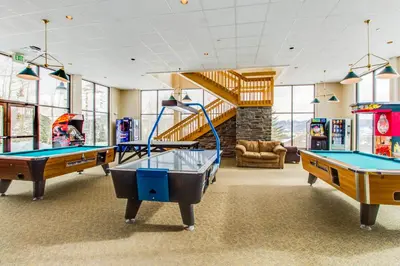 a gym with two pool tables and a slide at Treehouse 206F in Silverthorne