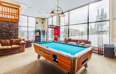 a living room with a pool table in it at Treehouse 206F in Silverthorne