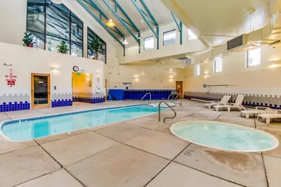 a large indoor swimming pool in a building with a large window at Treehouse 206F in Silverthorne