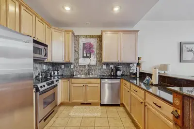 a kitchen with wooden cabinets and stainless steel appliances at La Riva Del Lago 209 in Dillon