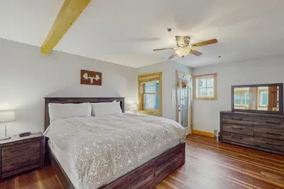 a bedroom with a bed and a ceiling fan at La Riva Del Lago 209 in Dillon
