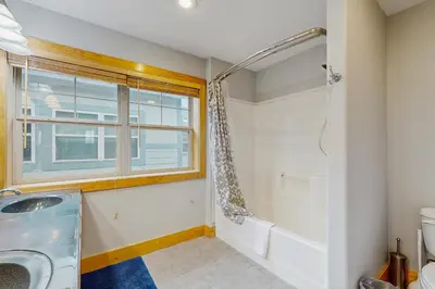 a bathroom with a shower and a sink and a window at La Riva Del Lago 209 in Dillon