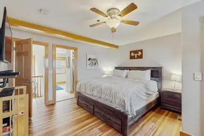 a bedroom with a bed and a ceiling fan at La Riva Del Lago 209 in Dillon