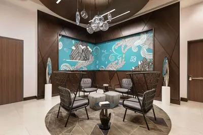 a waiting room with chairs and a colorful wall at Tru By Hilton Denver Downtown Convention Center in Denver