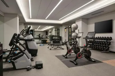 a gym with exercise equipment and a flat screen tv at Tru By Hilton Denver Downtown Convention Center in Denver