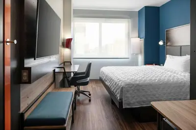 a hotel room with a bed and a desk and a tv at Tru By Hilton Denver Downtown Convention Center in Denver