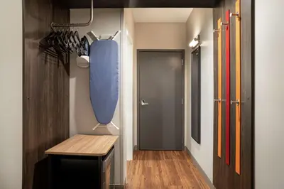 a hallway with a table and a blue bag at Tru By Hilton Denver Downtown Convention Center in Denver