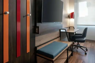 a room with a desk and a tv and a chair at Tru By Hilton Denver Downtown Convention Center in Denver