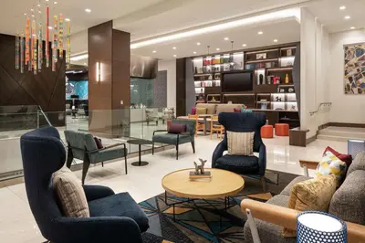 a lobby with couches and chairs and a table at Home2 Suites By Hilton Denver Downtown Convention Center in Denver