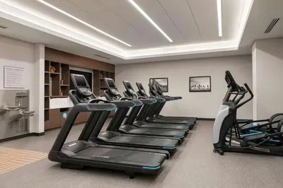 a row of tread machines in a gym at Home2 Suites By Hilton Denver Downtown Convention Center in Denver