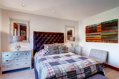 a bedroom with a large bed and two night stands at Premier 4 Bedroom Ski In, Ski Out Vacation Rental At The Timbers With The Best Access To Skiing In Keystone in Keystone