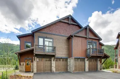 a large wooden house with a garage at Spacious 4 Bedroom Townhome In River Run Village Within Walking Distance To Gondola And Restaurants in Keystone