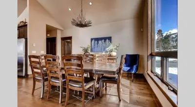 a dining room with a wooden table and chairs at Spacious 4 Bedroom Townhome In River Run Village Within Walking Distance To Gondola And Restaurants in Keystone