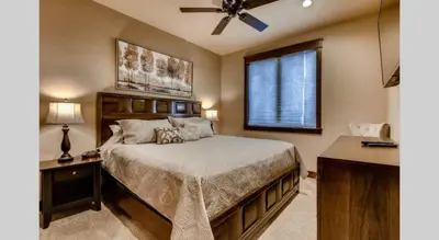 a bedroom with a bed and a ceiling fan at Spacious 4 Bedroom Townhome In River Run Village Within Walking Distance To Gondola And Restaurants in Keystone