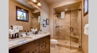 a bathroom with a shower and a toilet and a sink at Spacious 4 Bedroom Townhome In River Run Village Within Walking Distance To Gondola And Restaurants in Keystone