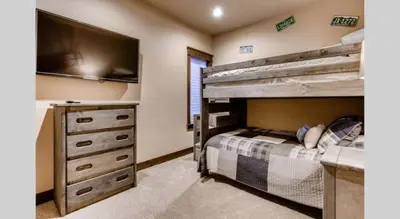 a bedroom with a bunk bed and a dresser at Spacious 4 Bedroom Townhome In River Run Village Within Walking Distance To Gondola And Restaurants in Keystone