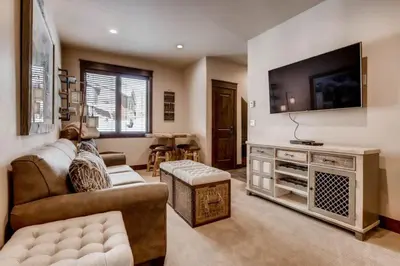 a living room with a couch and a tv at Spacious 4 Bedroom Townhome In River Run Village Within Walking Distance To Gondola And Restaurants in Keystone
