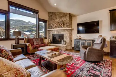 a living room with a fireplace and a tv at Spacious 4 Bedroom Townhome In River Run Village Within Walking Distance To Gondola And Restaurants in Keystone