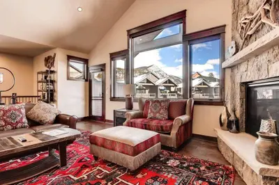 a living room with a couch and a fireplace at Spacious 4 Bedroom Townhome In River Run Village Within Walking Distance To Gondola And Restaurants in Keystone