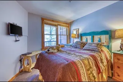 a bedroom with a bed with a teddy bear on it at 1 Bedroom Premier Mountain Condo In River Run Village Just A Short Walk To Shopping, Dining, And Skiing in Keystone