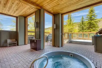 a large bathroom with a tub and a large window at 1 Bedroom Premier Mountain Condo In River Run Village Just A Short Walk To Shopping, Dining, And Skiing in Keystone
