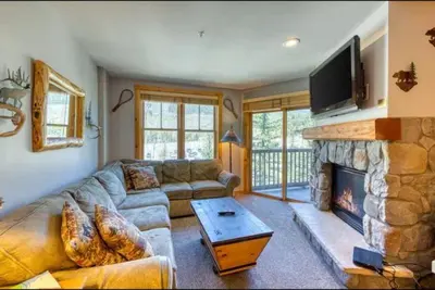 a living room with a couch and a fireplace at 1 Bedroom Premier Mountain Condo In River Run Village Just A Short Walk To Shopping, Dining, And Skiing in Keystone