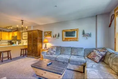 a living room with a couch and a table at 1 Bedroom Premier Mountain Condo In River Run Village Just A Short Walk To Shopping, Dining, And Skiing in Keystone