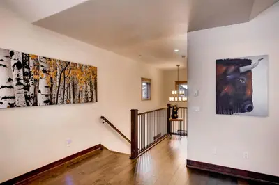 a hallway with two large paintings on the wall at Spacious 3 Bedroom Townhome In River Run Village Within Walking Distance To Gondola And Restaurants in Keystone