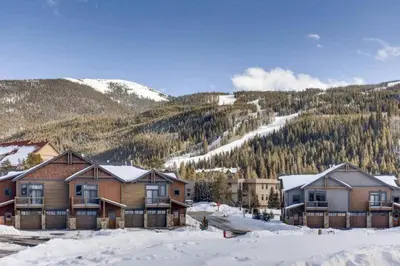 a group of houses in the snow with a mountain at Spacious 3 Bedroom Townhome In River Run Village Within Walking Distance To Gondola And Restaurants in Keystone