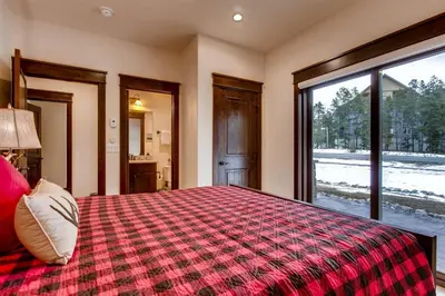 a bedroom with a large bed and a window at Spacious 3 Bedroom Townhome In River Run Village Within Walking Distance To Gondola And Restaurants in Keystone