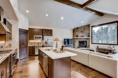 a large kitchen with a couch and a fireplace at Spacious 3 Bedroom Townhome In River Run Village Within Walking Distance To Gondola And Restaurants in Keystone