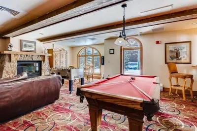 a living room with a pool table in it at Luxury 1 Bedroom Mountain Condo In River Run Village With Expansive Mountain Views And Walking Distance To Ski Slopes in Keystone